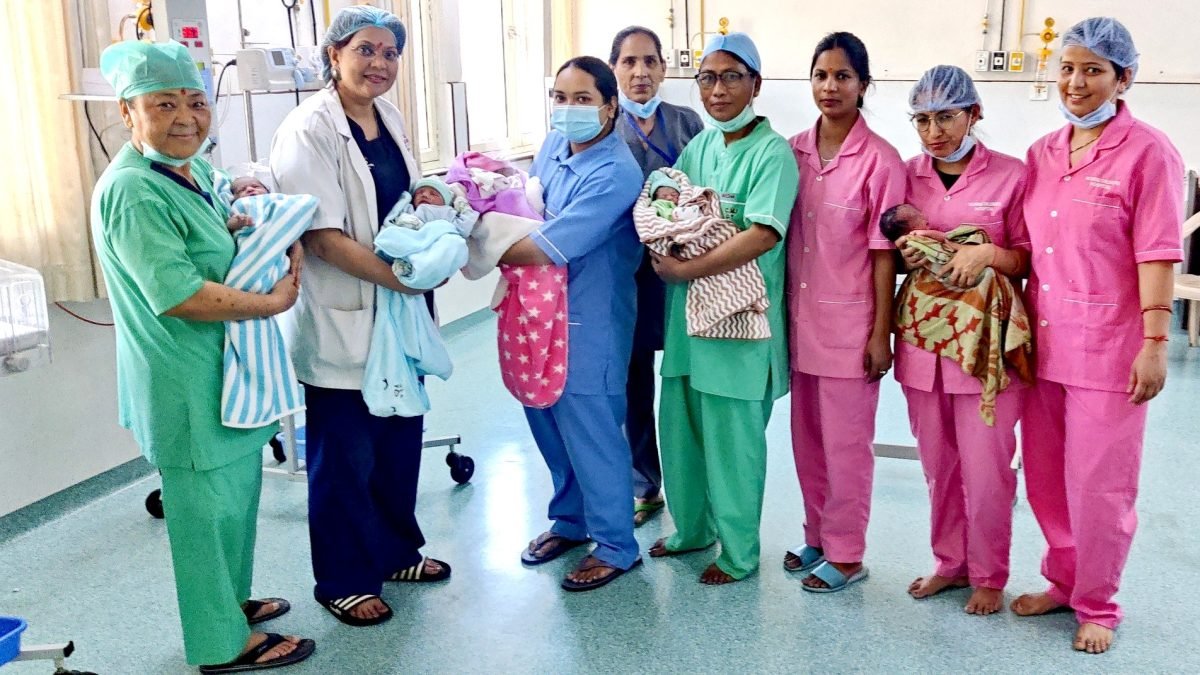 Dr. Sumita Prabhakar with IVF team and healthy babies in Dehradun