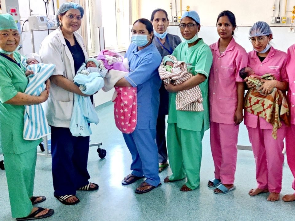Dr. Sumita Prabhakar with IVF team and healthy babies in Dehradun